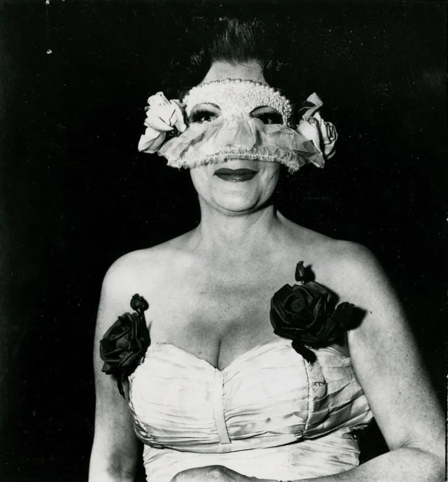 Diane Arbus - "LADY AT A MASKED BALL WITH TWO ROSES IN"